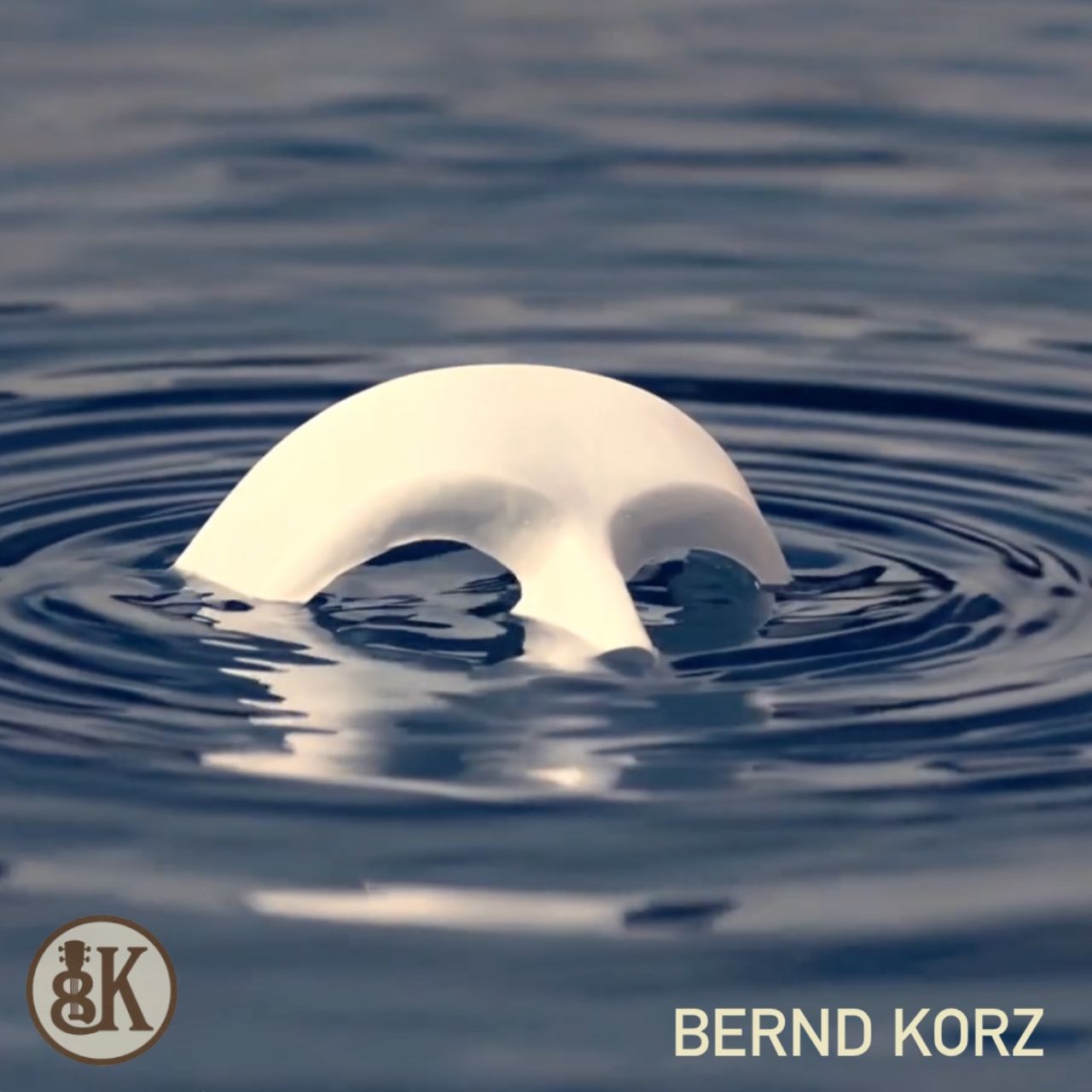 "A white mask floating on calm water, creating a mysterious and emotional atmosphere."